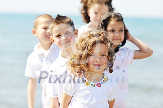 group of happy child on beach who have fun and play games group of happy child on beach who have fun and play games