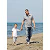 happy young  father and son have fun and enjoy time on beach at sunset and representing healthy family and support concept