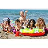 happy child group have fun on beach while playing with toys  running jumping