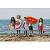 happy child group have fun on beach while playing with toys  running jumping