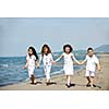 group of happy child on beach who have fun and play games