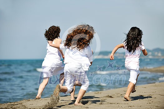 group of happy child on beach who have fun and play games group of happy child on beach who have fun and play games
