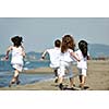 group of happy child on beach who have fun and play games