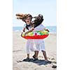 group of happy child on beach who have fun and play games