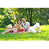 happy young couple with their children have fun at beautiful park outdoor in nature