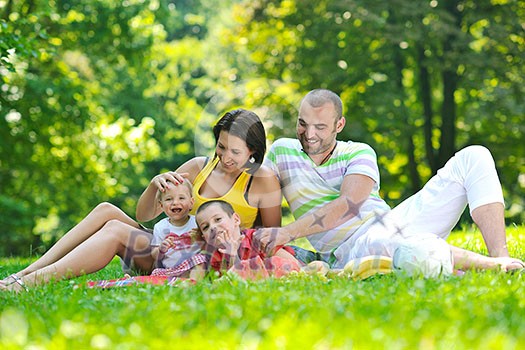 happy young couple with their children have fun at beautiful park outdoor in nature happy young couple with their children have fun at beautiful park outdoor in nature