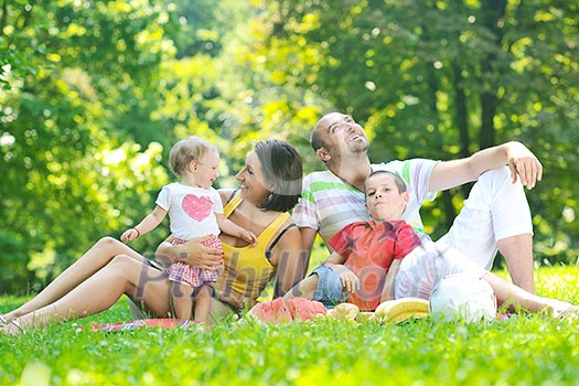 happy young couple with their children have fun at beautiful park outdoor in nature happy young couple with their children have fun at beautiful park outdoor in nature