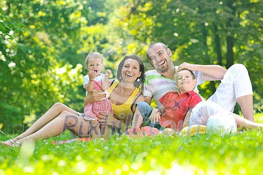 happy young couple with their children have fun at beautiful park outdoor in nature happy young couple with their children have fun at beautiful park outdoor in nature