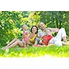 happy young couple with their children have fun at beautiful park outdoor in nature