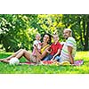 happy young couple with their children have fun at beautiful park outdoor in nature