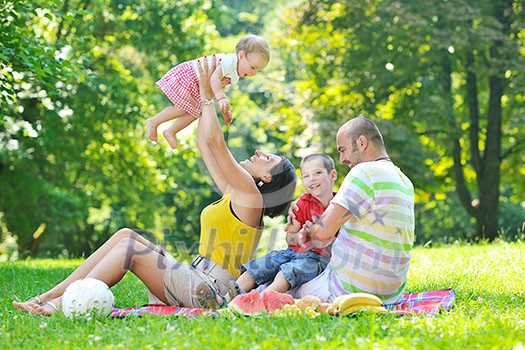 happy young couple with their children have fun at beautiful park outdoor in nature happy young couple with their children have fun at beautiful park outdoor in nature