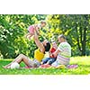 happy young couple with their children have fun at beautiful park outdoor in nature