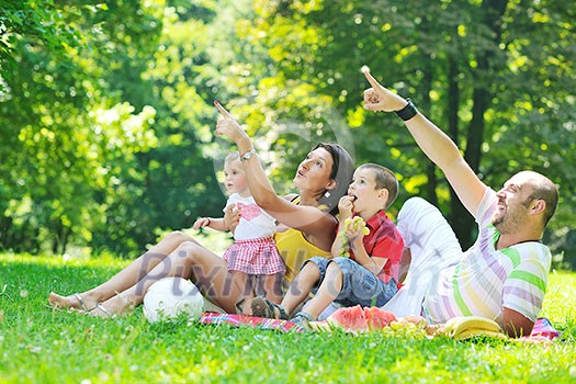 happy young couple with their children have fun at beautiful park outdoor in nature happy young couple with their children have fun at beautiful park outdoor in nature