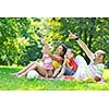 happy young couple with their children have fun at beautiful park outdoor in nature
