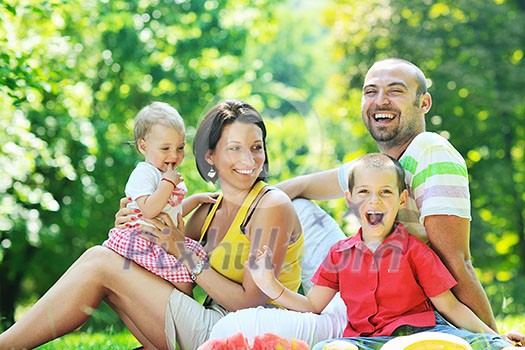 happy young couple with their children have fun at beautiful park outdoor in nature happy young couple with their children have fun at beautiful park outdoor in nature