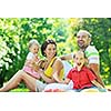 happy young couple with their children have fun at beautiful park outdoor in nature