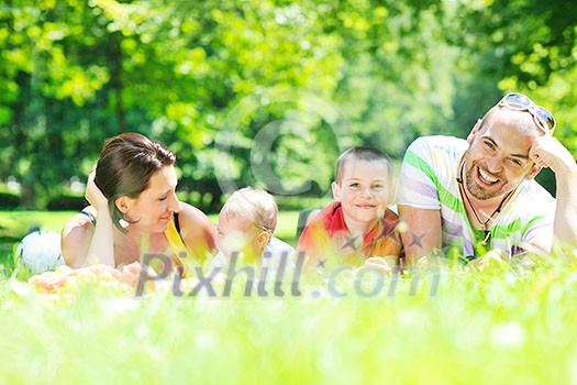 happy young couple with their children have fun at beautiful park outdoor in nature happy young couple with their children have fun at beautiful park outdoor in nature