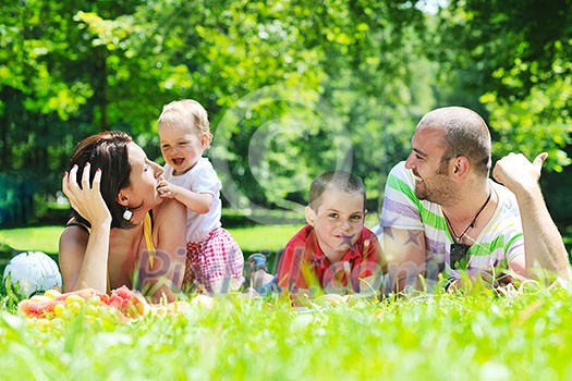 happy young couple with their children have fun at beautiful park outdoor in nature happy young couple with their children have fun at beautiful park outdoor in nature
