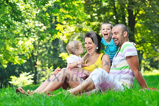 happy young couple with their children have fun at beautiful park outdoor in nature happy young couple with their children have fun at beautiful park outdoor in nature