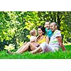 happy young couple with their children have fun at beautiful park outdoor in nature