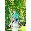 family father and son have fun at park on summer season and representing happines concept