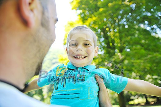 family father and son have fun at park on summer season and representing happines concept family father and son have fun at park on summer season and representing happines concept