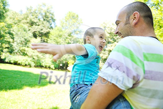 family father and son have fun at park on summer season and representing happines concept family father and son have fun at park on summer season and representing happines concept