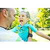 family father and son have fun at park on summer season and representing happines concept