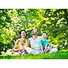 happy young couple with their children have fun at beautiful park outdoor in nature