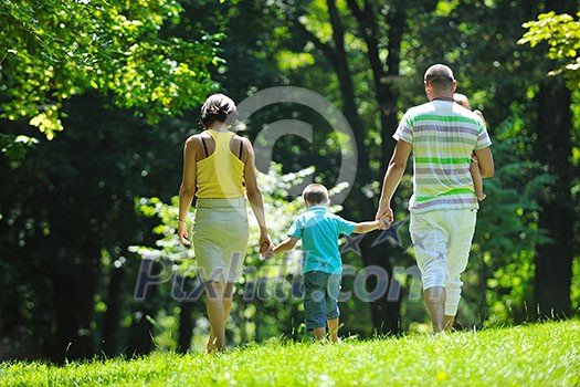 happy young couple with their children have fun at beautiful park outdoor in nature happy young couple with their children have fun at beautiful park outdoor in nature
