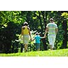 happy young couple with their children have fun at beautiful park outdoor in nature