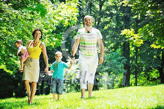 happy young couple with their children have fun at beautiful park outdoor in nature happy young couple with their children have fun at beautiful park outdoor in nature