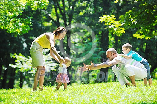 happy young couple with their children have fun at beautiful park outdoor in nature happy young couple with their children have fun at beautiful park outdoor in nature