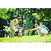 happy young couple with their children have fun at beautiful park outdoor in nature