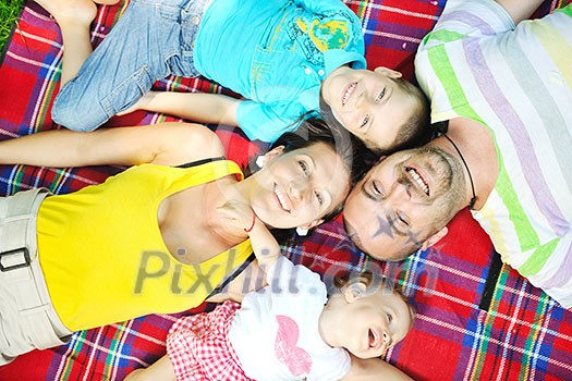 happy young couple with their children have fun at beautiful park outdoor in nature happy young couple with their children have fun at beautiful park outdoor in nature