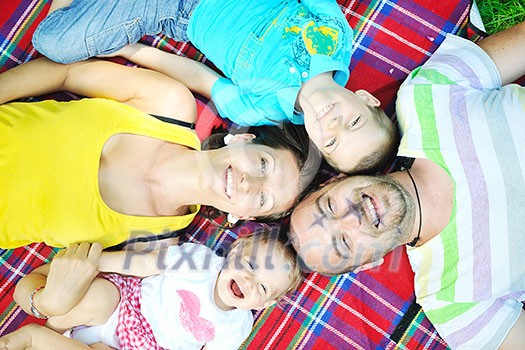 happy young couple with their children have fun at beautiful park outdoor in nature