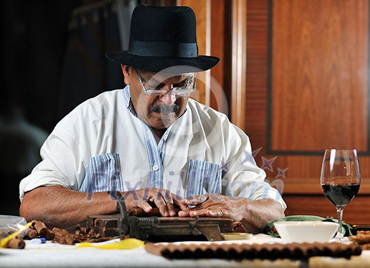 older senior man making luxury handmade cuban cigare older senior man making luxury handmade cuban cigare