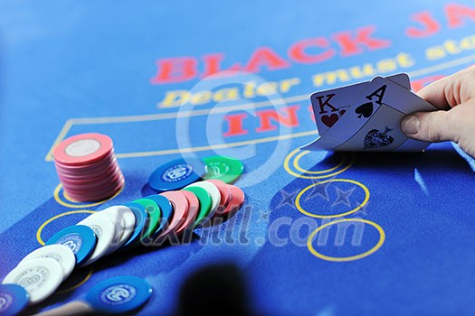 woman play black jack card game in casino on blue table woman play black jack card game in casino on blue table
