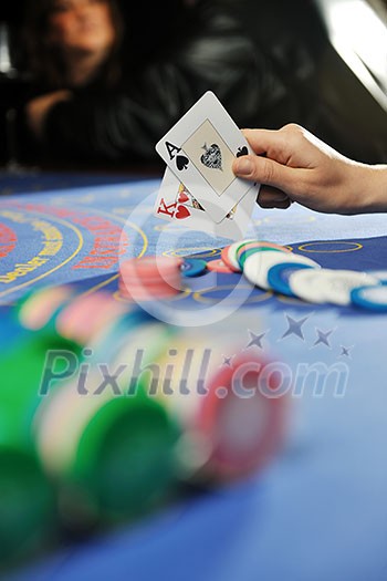 woman play black jack card game in casino on blue table woman play black jack card game in casino on blue table