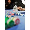 woman play black jack card game in casino on blue table