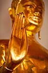 Buddha golden statue blessing hand, Wat Pho, Bangkok,  Thailand. Low point of view