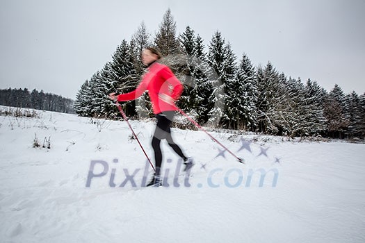 Cross-country skiing: young woman cross-country skiing on a winter day (motion blurred image) Cross-country skiing: young woman cross-country skiing on a winter day (motion blurred image)