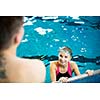 Female swimmer in an indoor swimming pool - doing crawl (shallow DOF)