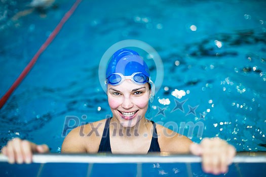 Female swimmer in an indoor swimming pool - doing crawl (shallow DOF) Female swimmer in an indoor swimming pool - doing crawl (shallow DOF)