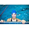 Female swimmer in an indoor swimming pool - doing crawl (shallow DOF)