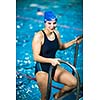 Female swimmer in an indoor swimming pool - doing crawl (shallow DOF)