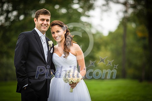 Just married, young wedding couple in a park, walking, savoring the moment on her big day (shallow DOF) Just married, young wedding couple in a park, walking, savoring the moment on her big day (shallow DOF)
