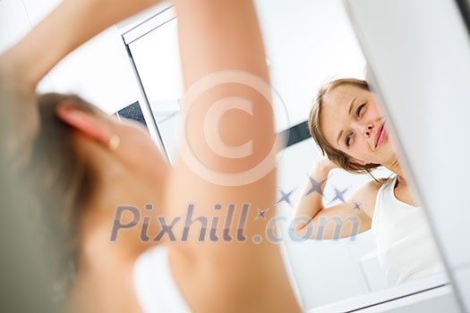 Morning stretch - Pretty, young woman in front of the mirror in the bathroom on an early morning Morning stretch - Pretty, young woman in front of the mirror in the bathroom on an early morning