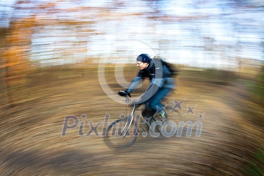 Bicycle riding in a city park on a lovely autumn/fall day (motion blur is used to convey movement) Bicycle riding in a city park on a lovely autumn/fall day (motion blur is used to convey movement)