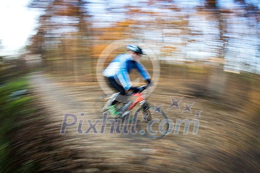 Bicycle riding in a city park on a lovely autumn/fall day (motion blur is used to convey movement) Bicycle riding in a city park on a lovely autumn/fall day (motion blur is used to convey movement)